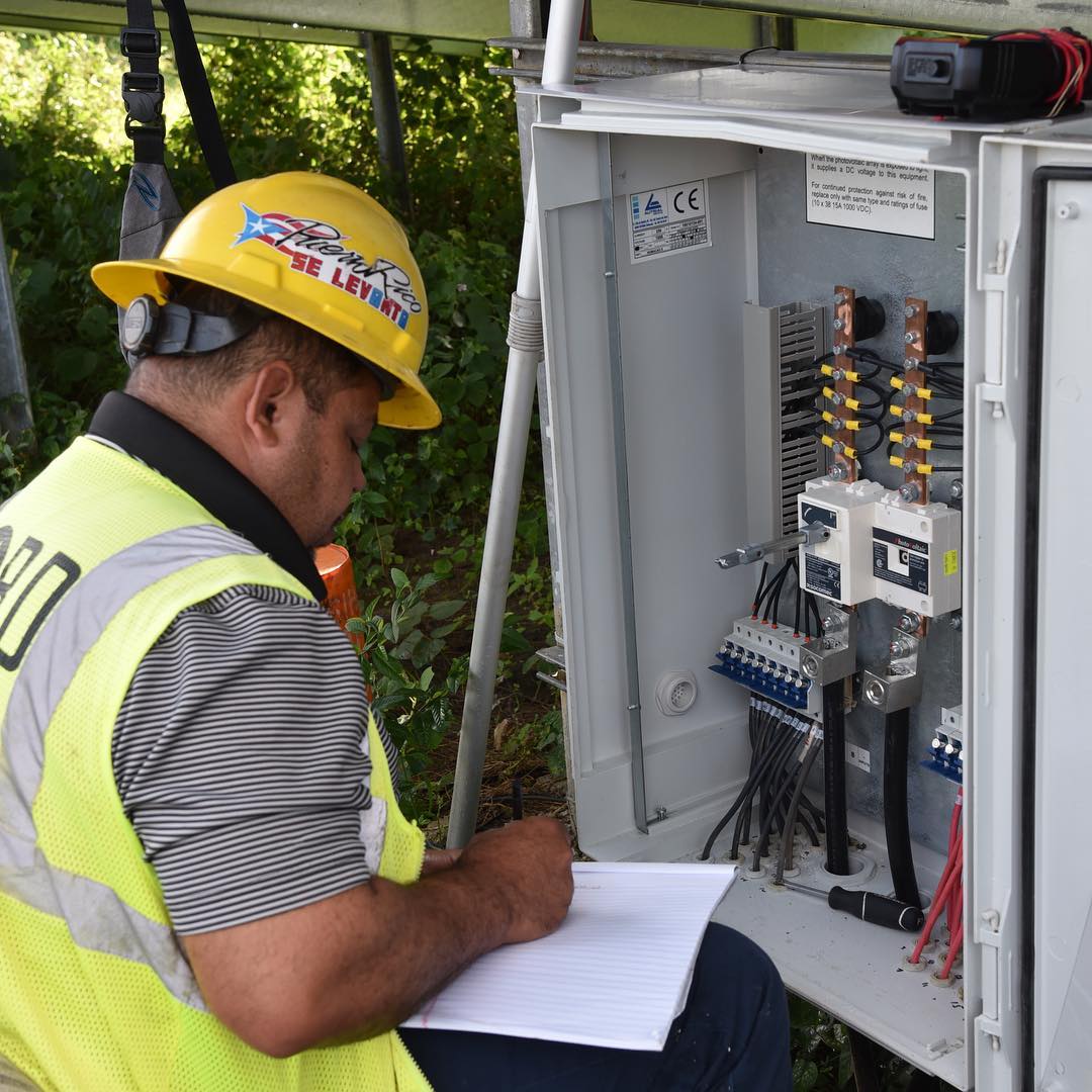 Construction working checking a breaker box