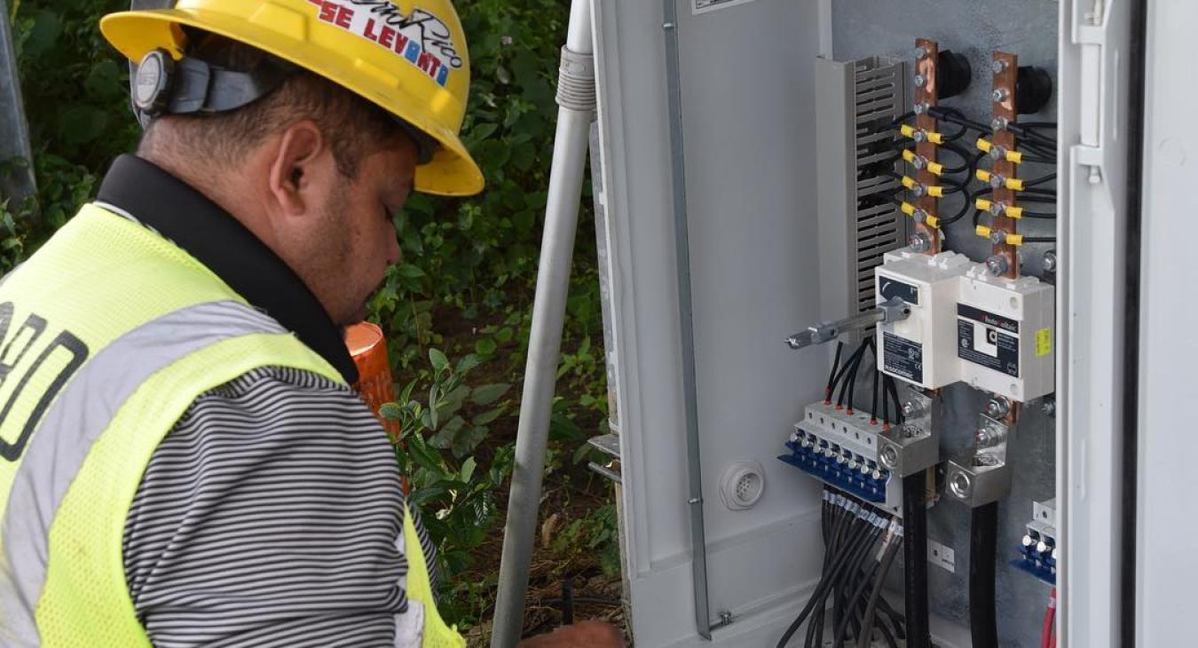 Construction working checking a breaker box